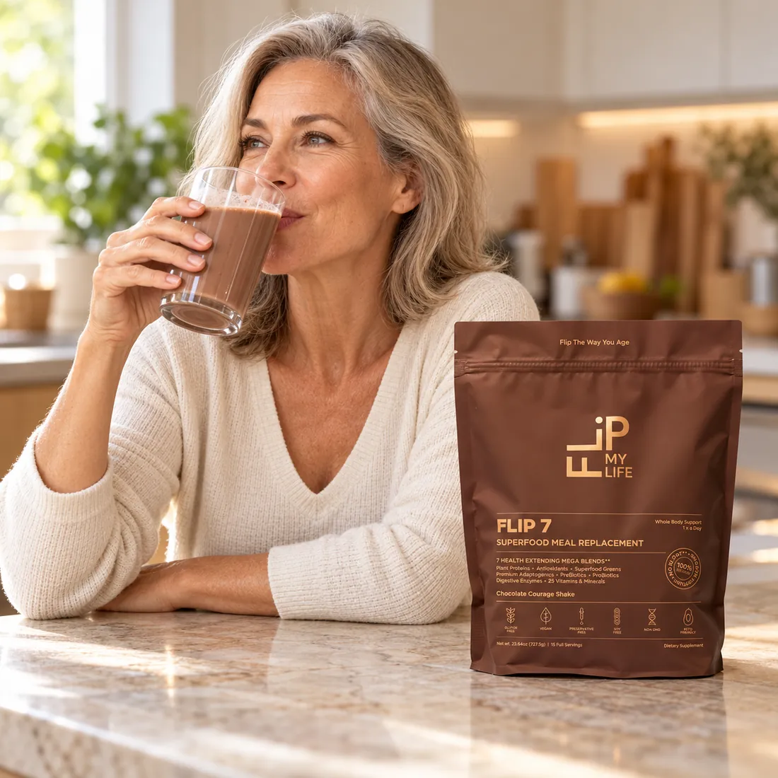A woman enjoying a FLIP 7 shake at her kitchen counter